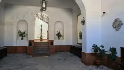 an empty church with stairs and a cross in the window at Antica Dimora in Termini Imerese