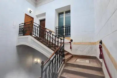 a staircase in a white building with a stair case at Antica Dimora in Termini Imerese