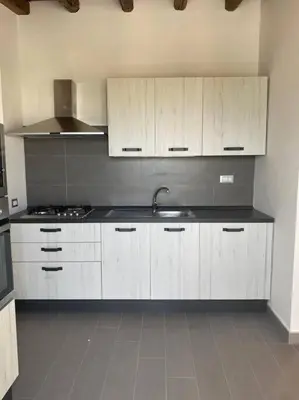 a kitchen with white cabinets and a sink at Antica Dimora in Termini Imerese