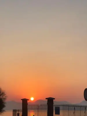 a sunset over the water with a fence at TOURIST HOUSE Le casette di Sofì in Bagheria
