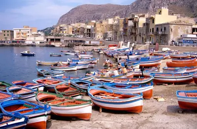 a group of boats sitting on the shore of a harbor at TOURIST HOUSE Le casette di Sofì in Bagheria