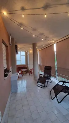 a large room with two chairs and a table at TOURIST HOUSE Le casette di Sofì in Bagheria