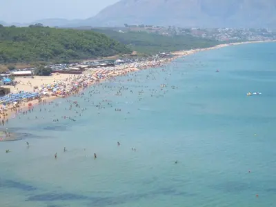 a group of people in the water at a beach at GB Case Vacanze Sicilia in Balestrate
