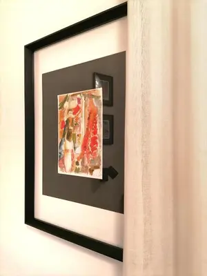 a picture hanging on a wall in a room at I Canti Comfort Rooms in Palermo