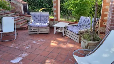 a patio with two chairs and a table at Villa Paola appartamento completo in Ciminna