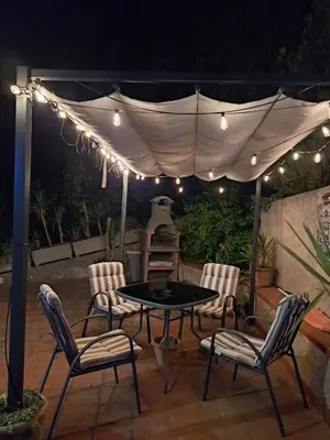 a patio with a table and chairs under a tent at Villa Paola appartamento completo in Ciminna