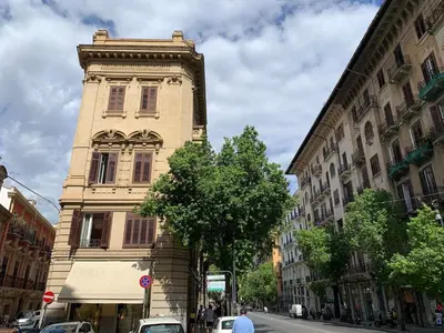 a tall building on the side of a street at Due Cani Apartment in Palermo