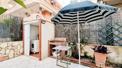 a black and white umbrella sitting on a patio at Casa Alamar 100 metri dal mare in Alcamo