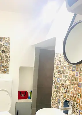 a bathroom with a toilet and a mirror at suite della cattedrale in Palermo