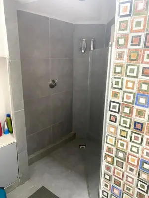 a shower with a glass door in a bathroom at suite della cattedrale in Palermo