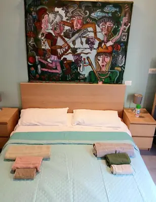 a bedroom with a bed with two towels on it at suite della cattedrale in Palermo