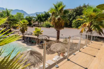 an aerial view of a resort with palm trees and a pool at RhelizeOne & Spa جميل in Palermo