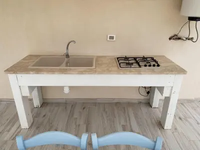 a kitchen counter with a sink and a stove at A Cantunera in San Vito lo Capo