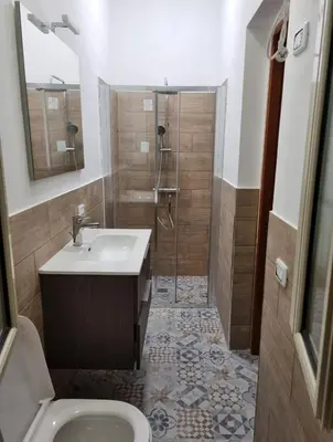 a bathroom with a shower and a sink and a toilet at casaafauka in Carini