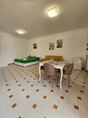 a room with a table and chairs and a couch at casaafauka in Carini