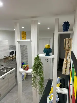 a kitchen with vases on shelves in a room at Casa Elivì Ballaró 2 passi dal centro storico, parcheggio e stazione ferroviaria in Palermo