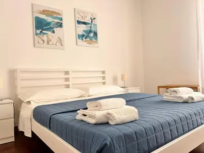 a bedroom with a large bed with towels on it at Casavacanze nel blu Maestrale in Isola delle Femmine