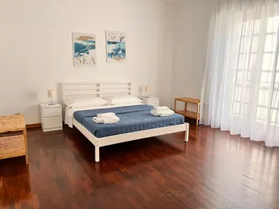 a bedroom with a bed with two towels on it at Casavacanze nel blu Maestrale in Isola delle Femmine