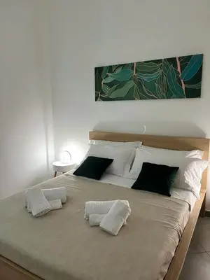 a large bed with four pillows on top of it at Casina al 32 in Palermo