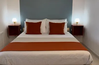 a bedroom with a large bed with two lamps at Casa Khalesia in Palermo