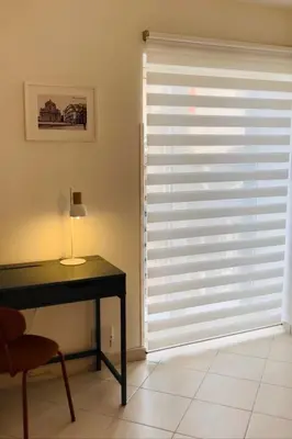 a room with a window with blinds on a door at Casa Khalesia in Palermo