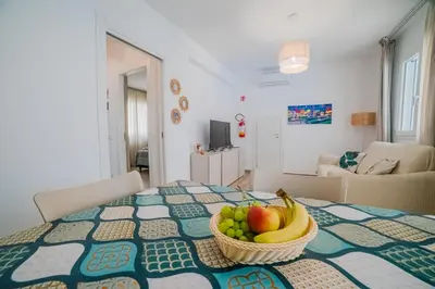 a basket of fruit on a table in a living room at Villa Capri - Private pool in Campofelice di Roccella