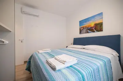 a bedroom with a bed with towels on it at Villa Amalfi in Campofelice di Roccella