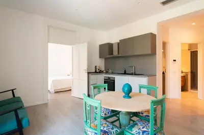 a kitchen with a table and chairs in a room at Dimora Florio in Palermo