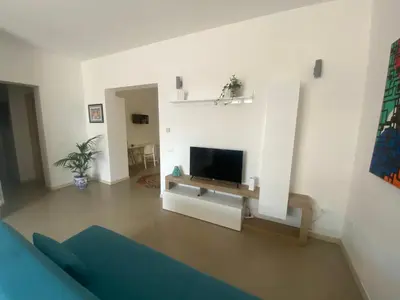 a living room with a tv on a wall at Casa Ciccio in Cinisi