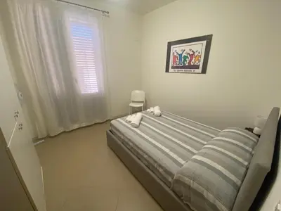 a bedroom with a bed and a window at Casa Ciccio in Cinisi