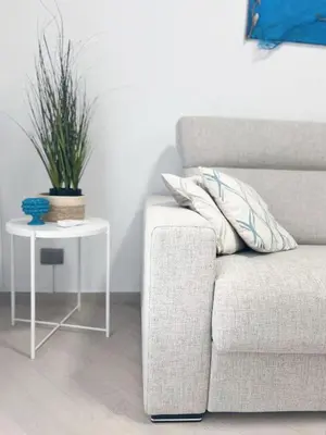 a living room with a couch and a table with a plant at Casa Marinaro in Castellammare del Golfo