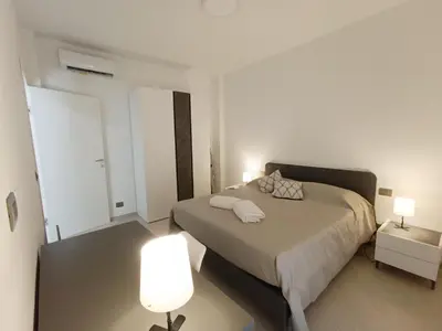 a bedroom with a bed with two lamps on it at Casa Marinaro in Castellammare del Golfo
