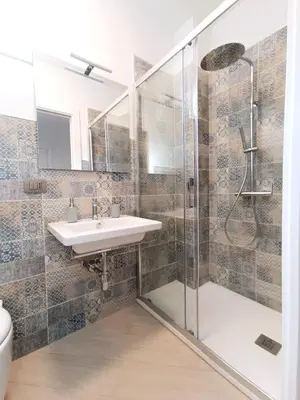 a bathroom with a glass shower and a sink at Casa Marinaro in Castellammare del Golfo