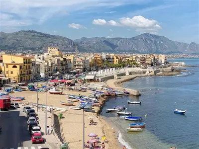 a group of boats on a beach near the water at Solemar Sicilia - Casa Tramonto in Bagheria