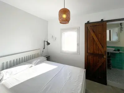 a bedroom with a bed and a window and a door at Solemar Sicilia - Casa Tramonto in Bagheria