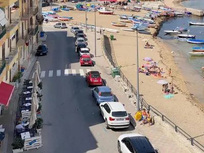 a group of cars parked on a beach at Solemar Sicilia - Casa Tramonto in Bagheria