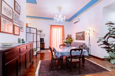 a dining room with a table and chairs at Stabile 16 Apartment in Palermo