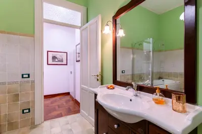 a bathroom with a sink and a mirror at Stabile 16 Apartment in Palermo