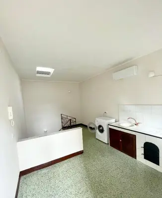 an empty kitchen with a sink and a washing machine at Conte125 in Cinisi