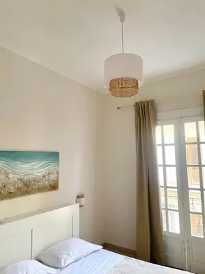 a bedroom with a bed and a painting on the wall at Conte125 in Cinisi