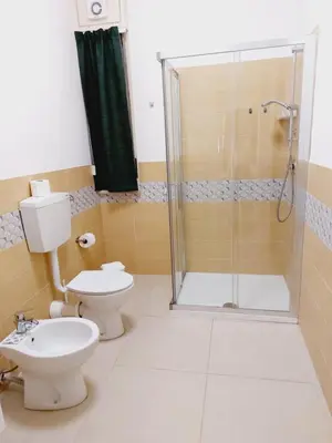 a bathroom with a shower and a toilet and a sink at Un Passo dal Porto in Palermo