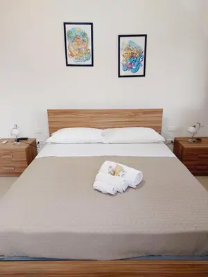 a bedroom with a bed with two towels on it at Un Passo dal Porto in Palermo