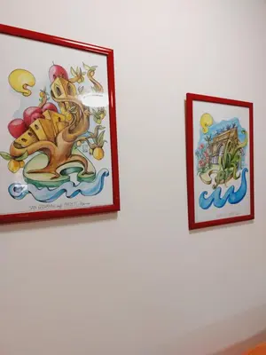 two framed pictures hanging on a white wall at Un Passo dal Porto in Palermo