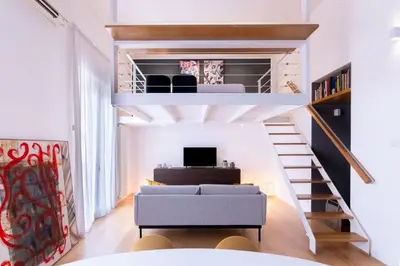 a living room with a loft bed and a couch at Oliveri Vintage House at Politeama in Palermo