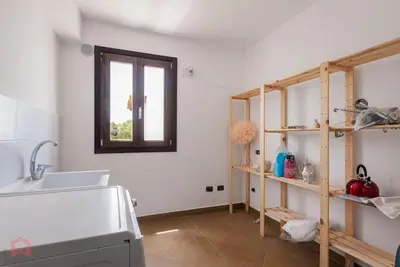 a kitchen with a sink and a window and a shelf at Posh villa with pool & jacuzzi in Balestrate