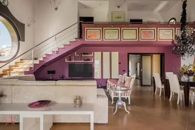 a living room with a couch and a staircase at Posh villa with pool & jacuzzi in Balestrate