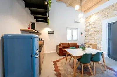 a kitchen with a blue refrigerator and a table at Mondello 2C casa vacanze in Palermo