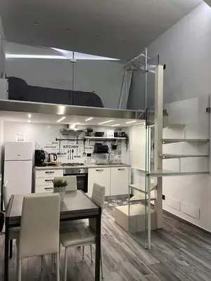 a kitchen and dining room with a table and chairs at Life Rooms in Misilmeri