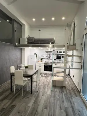 a kitchen and dining room with a table and chairs at Life Rooms in Misilmeri