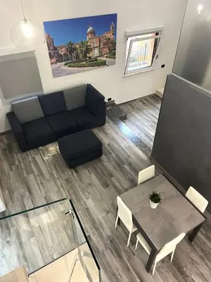 a living room with a couch and a table at Life Rooms in Misilmeri